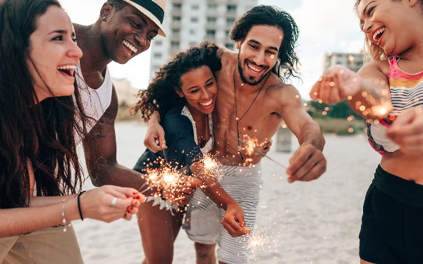 Friends lighting sparklers on the bech